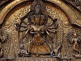 Kathmandu Bhaktapur 04-3 Bhaktapur Durbar Square Golden Gate Torana Taleju Bhawani Close Up Here is a close up of the four-headed and 10-armed figure of the goddess Taleju Bhawani directly above the door of the Golden Gate in Bhaktapurs Durbar Square. On the left Shri stand on a crocodile; on the right Lakshmi stands on a tortoise.